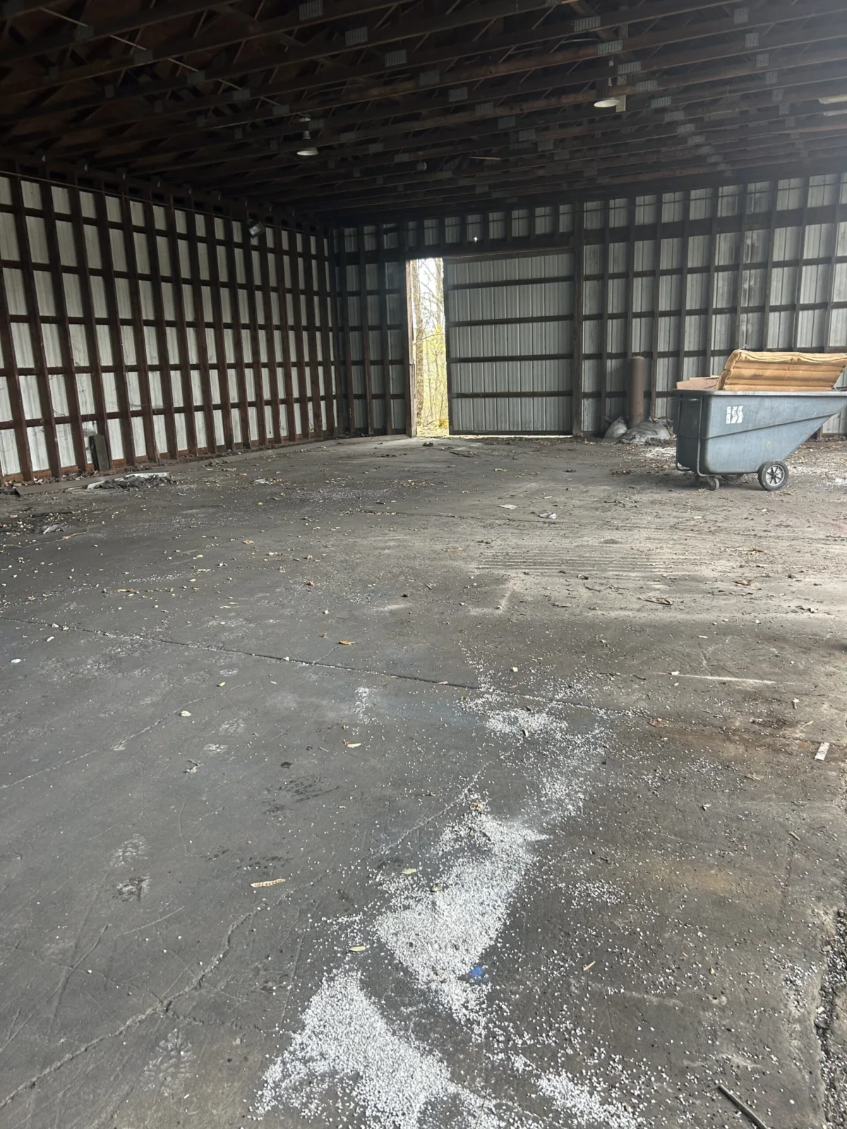 Empty storage building with a cart in the corner