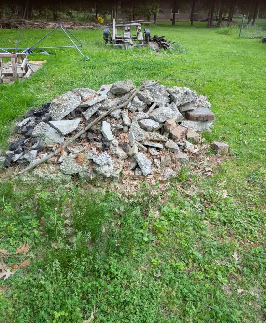Pile of broken concrete and asphalt chunks on a lawn