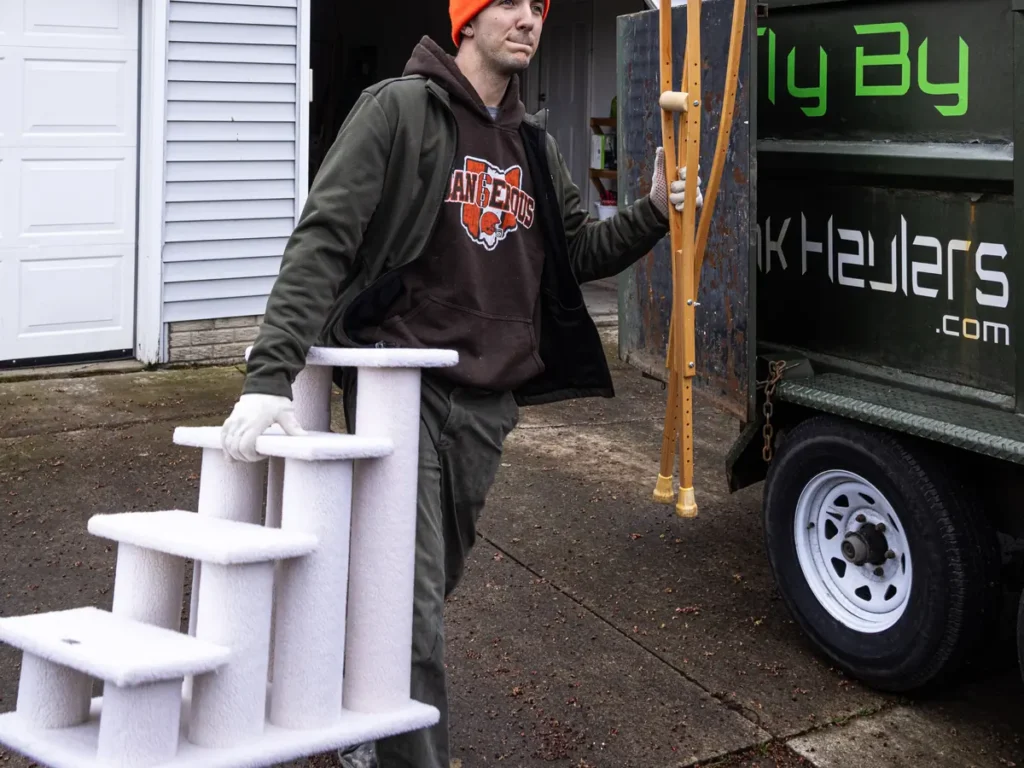 Crew member carrying household items to the Fly By truck