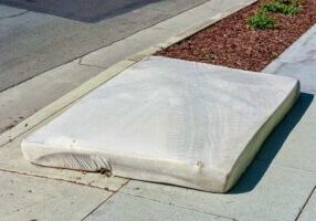 Old mattress dumped on the street. Illegal dumping disrupts natu