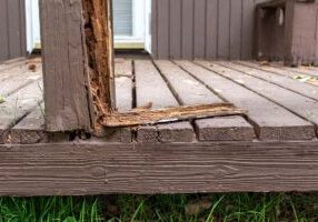 Old rotten damaged deck rail that is falling apart, dangerous an
